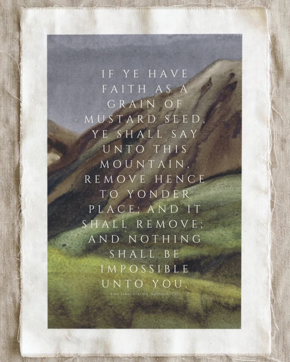 Matthew 17:20 in spaced white capitals over a painted green hillside, unframed on linen.